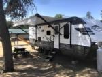 Parked trailer at site Bonanza Camping Resort - thumbnail
