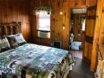 Knotty pine bedroom with in suite bathroom at WHIPPOORWILL MOTEL & CAMPSITES - thumbnail