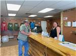 A young lady helping a man at the front desk at LARAMIE RV RESORT BY RJOURNEY - thumbnail