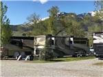 A row of motorhomes in the pull in sites at SUN OUTDOORS YELLOWSTONE NORTH - thumbnail
