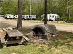 A large rock by a picnic bench at SUNSETVIEW FARM CAMPING AREA - thumbnail