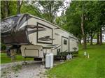 View larger image of A row of wooded pull thru gravel RV sites at NORTHERN KY RV PARK image #3