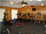 View larger image of A wood paneled exercise room at HITCHIN POST RV PARK image #4