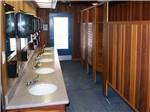 View larger image of A clean wood paneled bathroom at HITCHIN POST RV PARK image #5