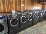 A row of brand new front loading washing machines at HITCHIN' POST RV PARK - thumbnail