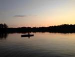 A rowboat on the water at sunset - thumbnail