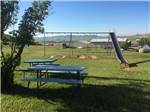 A picnic table and playground equipment at MOUNTAIN VIEW RV PARK & CAMPGROUND - thumbnail