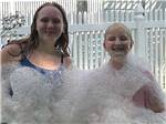 Kids covered in bubbles at Walnut Hills Campground and RV Park - thumbnail