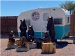 Bear statues next to a small trailer at USA RV PARK - thumbnail