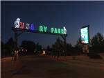 Park name in neon lights at entrance to RV park at USA RV PARK - thumbnail