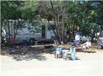 View larger image of A family sitting around a campsite at CASINI RANCH FAMILY CAMPGROUND image #3