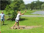 A woman playing horseshoes at RIP VAN WINKLE CAMPGROUNDS - thumbnail
