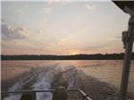 View larger image of Looking out the back of a moving boat at HARMONY LAKESIDE RV PARK  DELUXE CABINS image #11