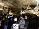 View larger image of A group taking a tour in a cave at RACCOON MOUNTAIN CAMPGROUND AND CAVERNS image #4