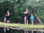 Family fishing on the grassy bank at BUTTERFLY CAMPING RESORT - thumbnail