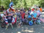 Group of children displaying decorated bikes in red, white and blue at BUTTERFLY CAMPING RESORT - thumbnail