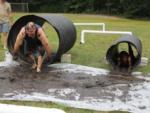 Man full of mud racing through a tunnel at BUTTERFLY CAMPING RESORT - thumbnail