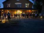 Night photo with children standing in front of lit campground office at BUTTERFLY CAMPING RESORT - thumbnail