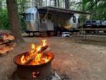 View larger image of Airstream trailer with campfire nearby at CROWS NEST CAMPGROUND image #6