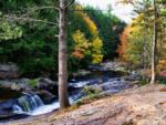 A stock photo of a river surrounded by autumn trees nearby at CROW'S NEST CAMPGROUND - thumbnail