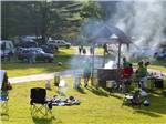 People barbecuing around the fire pit at HORSESHOE ACRES - thumbnail