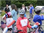 Kid riding their bikes in a parade at HORSESHOE ACRES - thumbnail