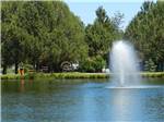 View larger image of Fishing in the pond with geiser-like water feature at BENDSISTERS GARDEN RV RESORT image #10