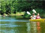 A couple kayaking in the river at BIG CEDAR CAMPGROUND & CANOE LIVERY - thumbnail