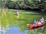 Families in boats in the river at BIG CEDAR CAMPGROUND & CANOE LIVERY - thumbnail