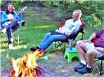 People sitting around a fire at BIG CEDAR CAMPGROUND & CANOE LIVERY - thumbnail