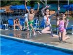 Kids jumping in a pool at JELLYSTONE PARK AT NATURAL BRIDGE - thumbnail
