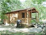 View larger image of Cabin with front porch and grill outside at MARTHAS VINEYARD FAMILY CAMPGROUND image #4