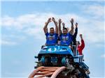 People at the crest of a roller coaster - thumbnail