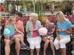 Multi generations enjoying pizza and cotton candy - thumbnail