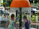 A couple of kids playing in the splash pad at AVALON CAMPGROUND - thumbnail