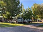 View larger image of Gravel road and RVs in grassy sites at BEAVERHEAD RIVER RV PARK  CAMPGROUND image #1