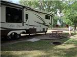 A travel trailer in a gravel site at BADLANDS / WHITE RIVER KOA HOLIDAY - thumbnail