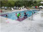 Campers enjoying the swimming pool at BADLANDS / WHITE RIVER KOA HOLIDAY - thumbnail
