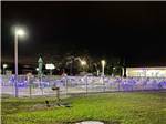 The fence around the swimming pool lit up at CYPRESS CAMPGROUND & RV PARK - thumbnail
