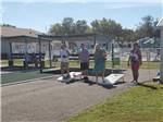Couples playing corn hole at CYPRESS CAMPGROUND & RV PARK - thumbnail