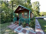 The brown and green wooden cabin rental at KNOXVILLE CAMPGROUND - thumbnail