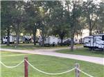 RVs in well-maintained grass sites at Jamestown Campground - thumbnail