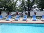View larger image of Blue chaise lounge chairs overlooking the pool at BAR HARBOR RV PARK  MARINA image #6