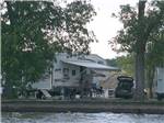 View larger image of Couple sitting at their RV under the awning at BAR HARBOR RV PARK  MARINA image #12