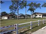View larger image of One of the grassy areas with buildings at FORT MYERS RV RESORT image #8