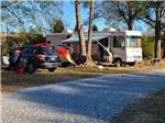 RV parked by trees at Cunningham RV Park - thumbnail