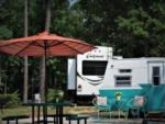 Red umbrella by vintage trailer at Pine Ridge Campground - thumbnail
