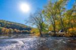 Lake view with fall trees at Kittatinny River Beach Campground - thumbnail