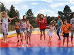 Children on a bounce pad at JELLYSTONE PARK ESTES - thumbnail