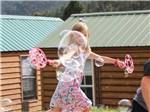 Little girl playing with bubbles at JELLYSTONE PARK ESTES - thumbnail